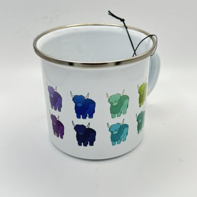 The Blue Rainbow Highland Coos Enamel Mug showcases a sleek white enamel body with a stylish silver rim, adorned with a vibrant pattern of Highland Coos in shades of blue, green, and purple. This eye-catching enamel mug is perfect for lovers of unique drinkware and features an attached string with tag on its handle. The design stands out beautifully against the plain white background, making this mug an ideal addition to your collection or as a thoughtful gift. Perfect for searches related to enamel mugs with colorful patterns and Highland Coos themed drinkware.