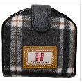 Introducing the Black Grey Tartan Wallet, a stylish and compact purse featuring a chic black, white, and gray plaid pattern. This elegant accessory boasts a sleek black flap and a distinctive brown patch adorned with a striking red emblem. Ideal for fashion enthusiasts who appreciate timeless plaid designs in their accessories, this tartan wallet is the perfect blend of classic elegance and modern flair.