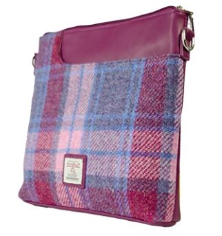 The trendy Harris Tweed pink messenger bag features a square design with an eye-catching pink and purple plaid pattern. It boasts a solid burgundy top panel, a distinctive front label, and elegant silver hardware, making it the perfect fashion accessory for style-conscious individuals.