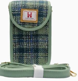 Introducing the Moss Green Mobile Phone Bag, the perfect plaid-patterned accessory for fashion-forward individuals. This stylish phone holder boasts a secure flap closure with a gold snap button and elegant fabric trim. Complete with a matching detachable shoulder strap, this phone bag is both practical and chic. The front features an eye-catching label with logo and text to enhance your style statement. Ideal for carrying your essentials in style, this moss green bag is a must-have accessory for anyone seeking convenience without sacrificing elegance.