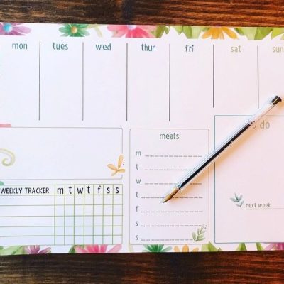 Discover the perfect Floral Weekly Planner featuring elegant floral borders, set beautifully on a wooden surface. This planner is designed to boost your productivity with dedicated sections for daily planning, a meals tracker, an organized to do list, and a comprehensive weekly tracker. Plus, enjoy the convenience of having a pen ready on this essential weekly planner.