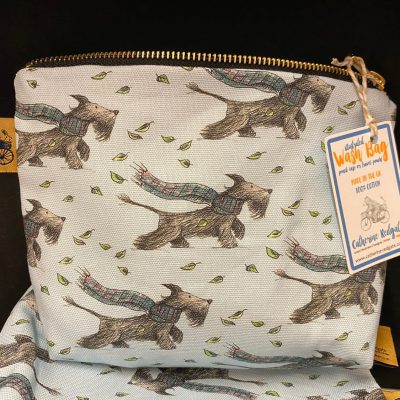 Introducing the Scottie Dog Wash Bag – a charming zippered fabric wash bag adorned with adorable Scottie dogs in colorful scarves amidst leafy patterns. Crafted from 100% cotton, this stylish and durable Scottie dog-themed travel accessory is a must-have for keeping your essentials organized.