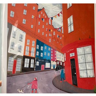 The Edinburgh Street A3 Print offers a stunning illustration of a picturesque Edinburgh street scene, perfect for home decor enthusiasts and art collectors. Featuring vibrant colors with tall, narrow buildings in striking red, orange, and blue hues, this print beautifully captures the essence of Edinburghs unique architecture. It depicts an engaging visual narrative with two people walking their dog on a leash under fluttering bunting above lively shop fronts. Enhance your space with this captivating piece of Edinburgh wall art that brings the citys charm into your home.