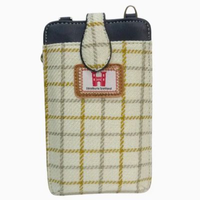 Introducing our stylish plaid phone pouch with strap, designed in a classic tartan pattern. This trendy phone accessory features a small leather patch showcasing a castle emblem alongside the text Strathclyde Scotland. The elegant color palette combines shades of beige, yellow, and black, making it the perfect choice for adding a touch of Scottish flair to your everyday look.