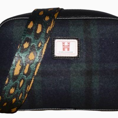 Discover our chic dark plaid handbag with an eye-catching leopard print shoulder strap and stylish tassel zipper. Featuring a distinctive square logo patch on the front, this trendy bag is the perfect accessory for fashion-forward individuals seeking a unique blend of patterns and functionality.