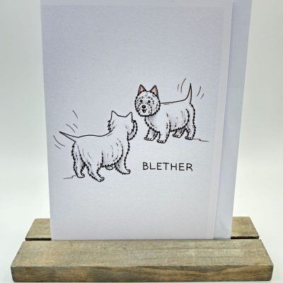 Discover our charming greeting card featuring two adorable cartoon terriers with wagging tails, ideal for dog lovers. The playful design includes the word BLETHER boldly printed below, adding a touch of humor. Perfectly displayed on a wooden stand against a minimalist background, this unique greeting card is sure to delight recipients and add joy to any occasion. Ideal for pet enthusiasts or as a conversation starter in your home decor collection.