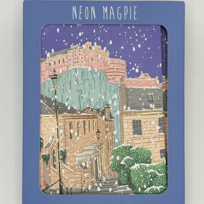Introducing a stunning boxed set of six cards and envelopes by Neon Magpie, perfect for capturing the magic of a snowy street scene. Experience the charm of historic buildings and a cliffside castle under a dazzling starry night sky. With gently falling snow, these beautifully illustrated holiday cards are ideal for sending seasonal greetings or sharing winters wonder. Get your Neon Magpie card set today and delight in the enchanting spirit of winter landscapes!.