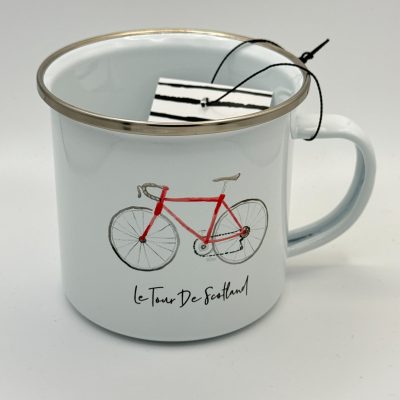 Discover our **white enamel mug with silver rim**, beautifully designed with a vibrant **red bicycle illustration** and the phrase **Le Tour De Scotland.** Perfect for cycling enthusiasts, this eye-catching mug also features a chic **black and white striped tag** attached to the handle with a sleek black string. Enhance your collection with this unique and stylish piece today!.